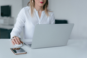 A woman at a computer in a white shirt doing some online software training