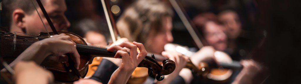 Image of three Violin players.